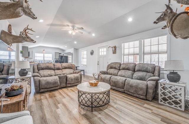 living area featuring light wood finished floors, baseboards, vaulted ceiling, recessed lighting, and a ceiling fan