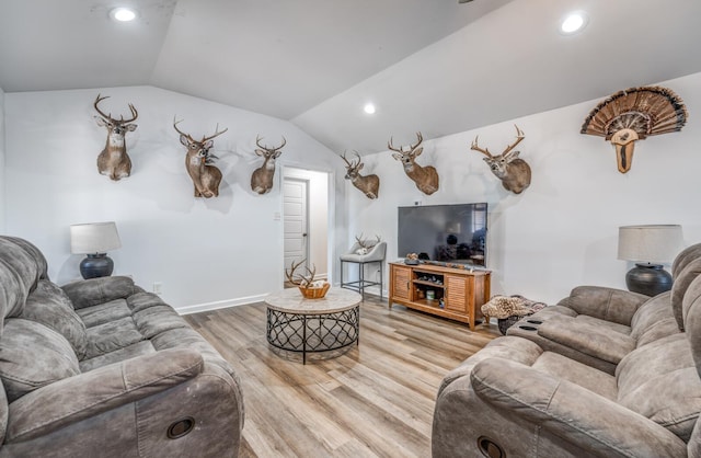 living area with vaulted ceiling, recessed lighting, baseboards, and light wood finished floors