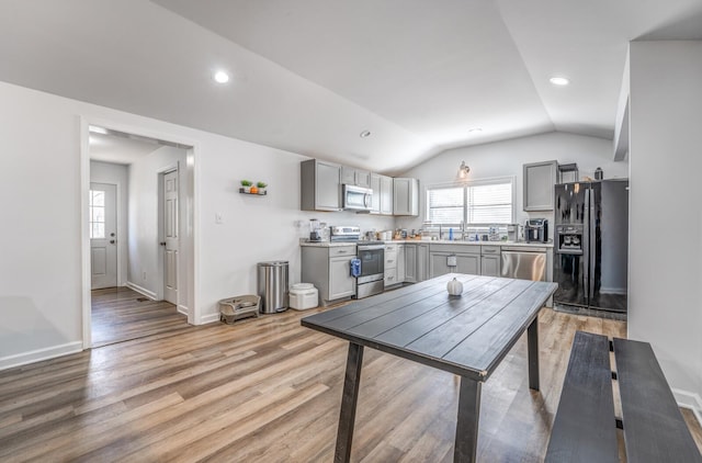 dining area featuring vaulted ceiling, recessed lighting, baseboards, and light wood finished floors