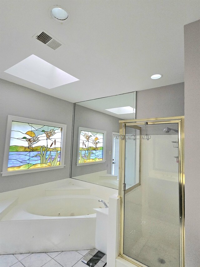 full bath with visible vents, tile patterned flooring, a tub with jets, and a skylight