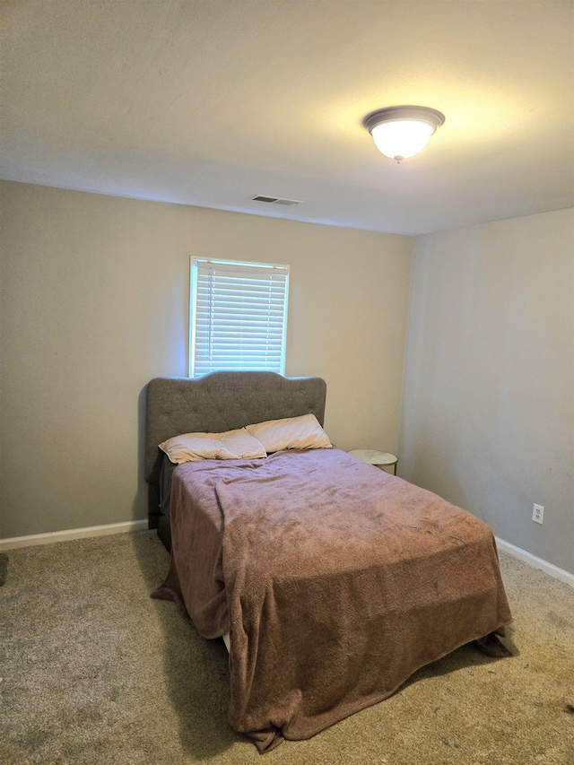 carpeted bedroom with baseboards and visible vents