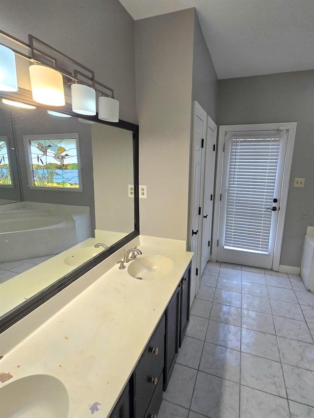 bathroom with double vanity, a sink, and a bath