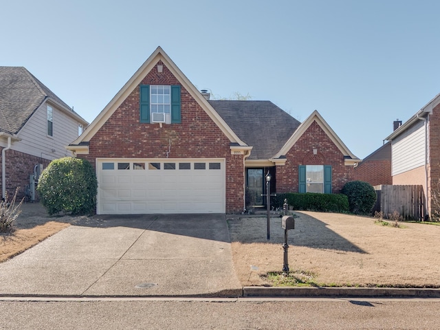 9995 Woodland Birch Dr, Lakeland, TN 38002 - traditional home with brick siding, cooling unit, concrete driveway, and roof with shingles