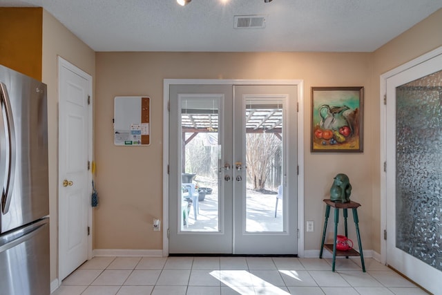 9995 Woodland Birch Dr, Lakeland, TN 38002 - doorway to outside with light tile patterned flooring, visible vents, french doors, and a textured ceiling