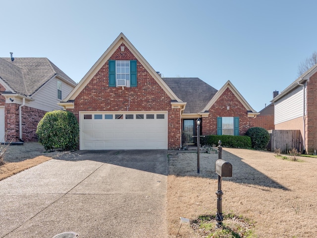 9995 Woodland Birch Dr, Lakeland, TN 38002 - traditional-style house featuring a garage, brick siding, concrete driveway, and a shingled roof