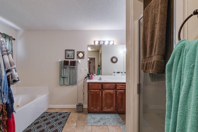 9995 Woodland Birch Dr, Lakeland, TN 38002 - bathroom with tile patterned floors, a textured ceiling, a shower stall, a bath, and vanity