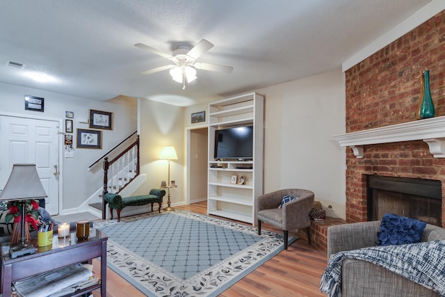 9995 Woodland Birch Dr, Lakeland, TN 38002 - living area featuring wood finished floors, visible vents, ceiling fan, stairs, and a textured ceiling