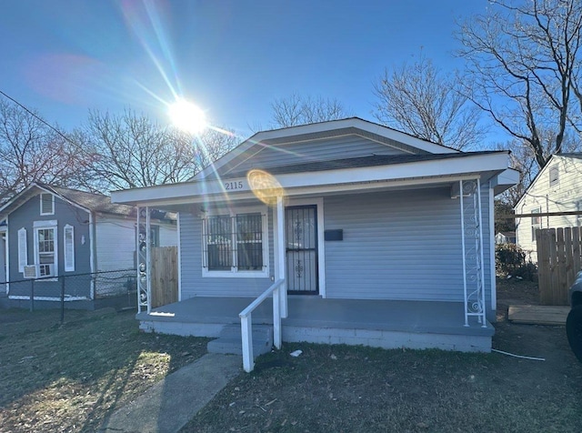 bungalow-style home with cooling unit, fence, and covered porch