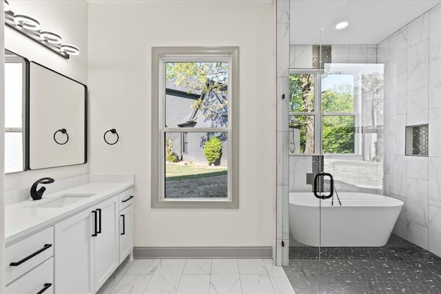 bathroom featuring vanity, marble finish floor, a soaking tub, baseboards, and recessed lighting