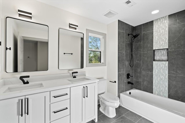 bathroom featuring visible vents, a sink, double vanity, and toilet