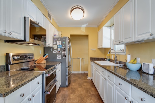 kitchen with crown molding, dark stone counters, stainless steel appliances, white cabinetry, and a sink