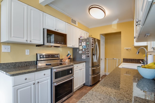 kitchen featuring white cabinetry, ornamental molding, appliances with stainless steel finishes, and a sink