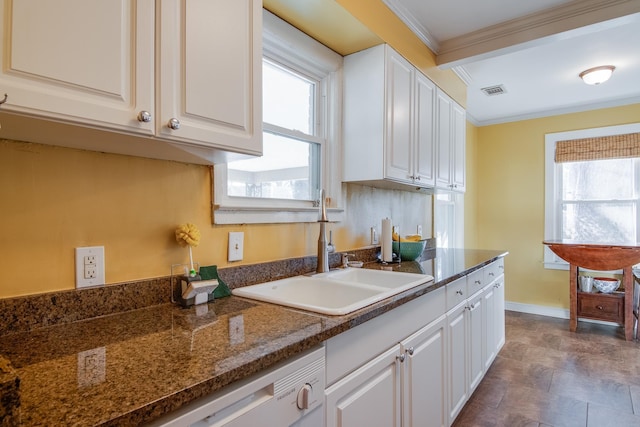 kitchen with plenty of natural light, white cabinets, and crown molding