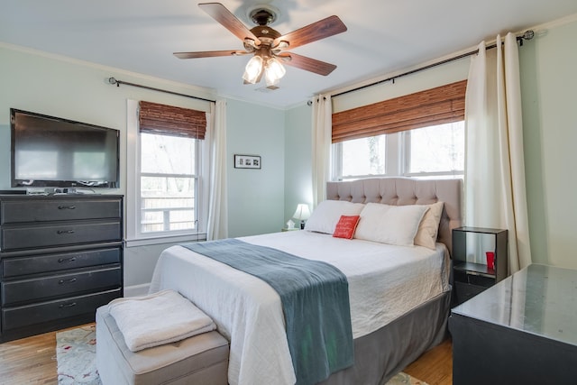 bedroom with visible vents, multiple windows, light wood-style flooring, and crown molding