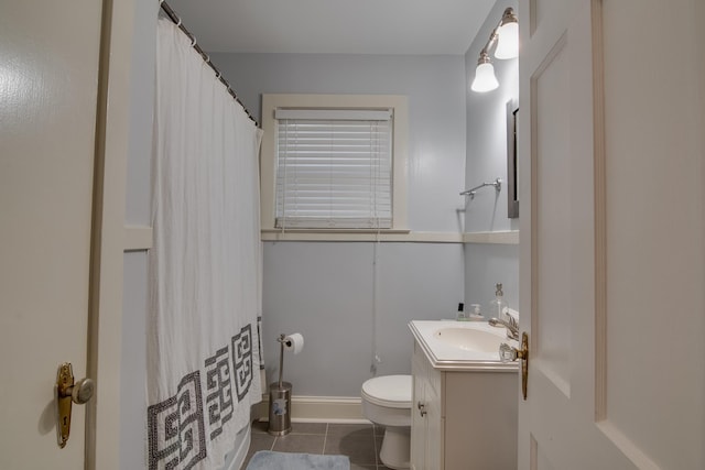bathroom featuring a shower with shower curtain, toilet, vanity, and tile patterned flooring