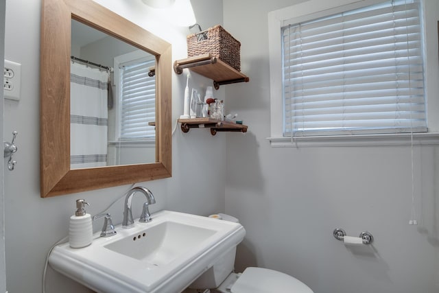 full bath with toilet and a sink