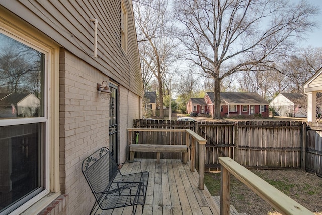 wooden deck with a residential view and fence