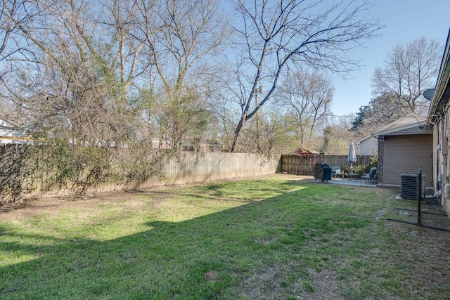 view of yard with a fenced backyard, cooling unit, and a patio