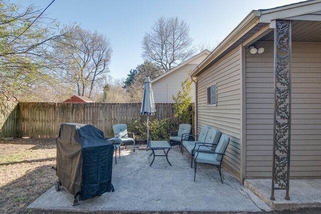 view of patio with grilling area and fence