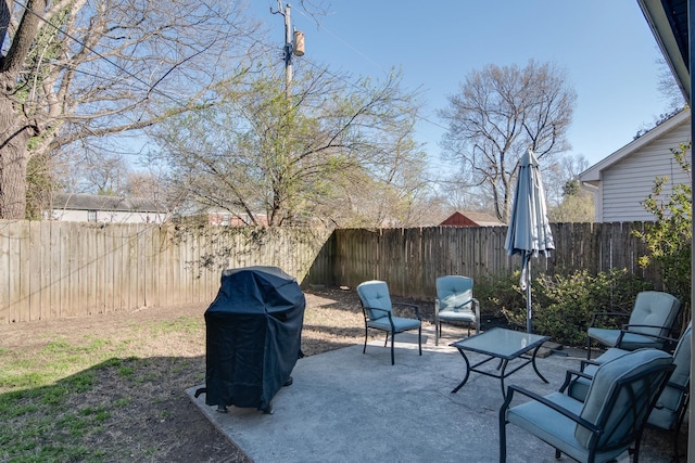 view of patio with grilling area and a fenced backyard