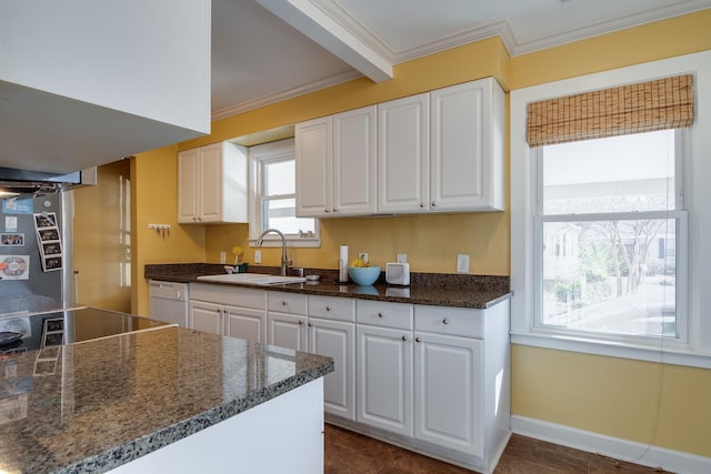 kitchen featuring crown molding, white cabinets, and a sink