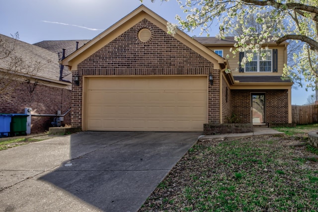 12065 Hidden Trl, Arlington, TN 38002 - traditional-style home featuring brick siding, an attached garage, concrete driveway, and fence