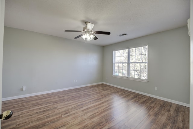 12065 Hidden Trl, Arlington, TN 38002 - empty room featuring wood finished floors, baseboards, visible vents, ceiling fan, and a textured ceiling