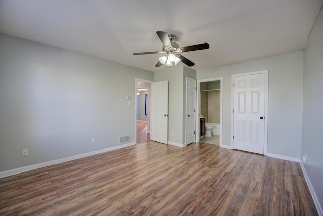 12065 Hidden Trl, Arlington, TN 38002 - unfurnished bedroom with a ceiling fan, wood finished floors, visible vents, baseboards, and connected bathroom