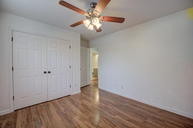 12065 Hidden Trl, Arlington, TN 38002 - unfurnished bedroom with ceiling fan, wood finished floors, a closet, and baseboards