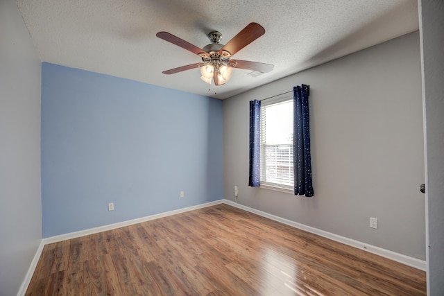 12065 Hidden Trl, Arlington, TN 38002 - empty room with a ceiling fan, wood finished floors, baseboards, and a textured ceiling