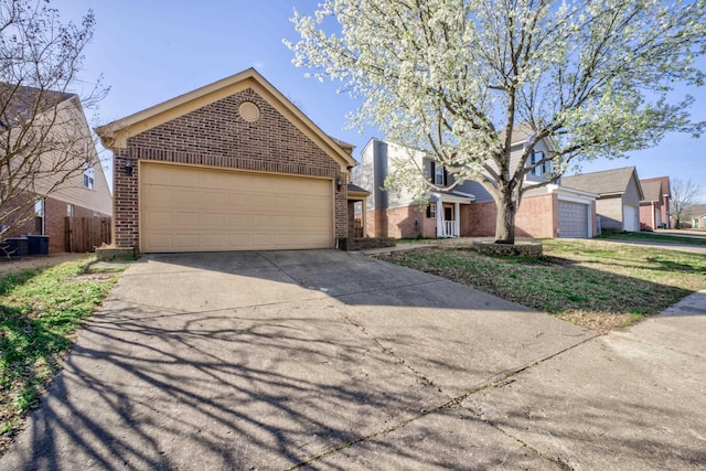 12065 Hidden Trl, Arlington, TN 38002 - view of front of home with an attached garage, brick siding, and driveway