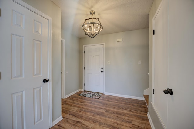12065 Hidden Trl, Arlington, TN 38002 - entrance foyer with a notable chandelier, a textured ceiling, baseboards, and wood finished floors