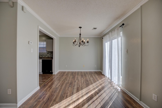12065 Hidden Trl, Arlington, TN 38002 - unfurnished dining area with a chandelier, a textured ceiling, dark wood finished floors, and crown molding