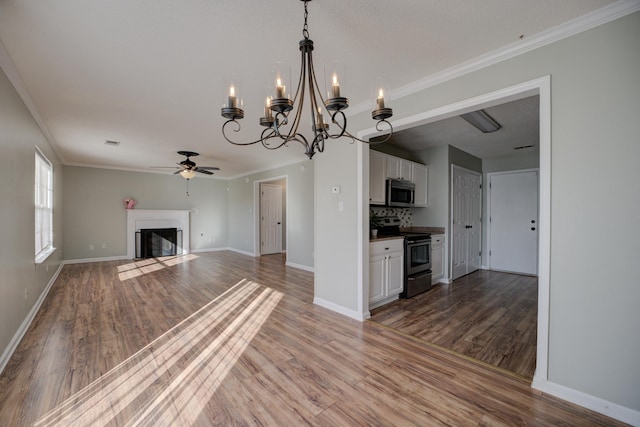 12065 Hidden Trl, Arlington, TN 38002 - unfurnished living room with wood finished floors, a fireplace with flush hearth, ceiling fan with notable chandelier, and ornamental molding