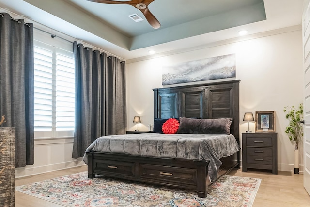 12753 Hollow Oak Dr S, Arlington, TN 38002 - bedroom with light wood-type flooring, visible vents, a raised ceiling, and baseboards