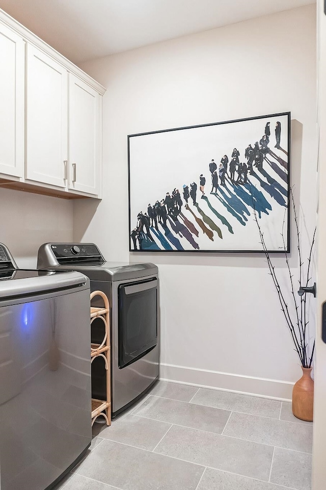 12753 Hollow Oak Dr S, Arlington, TN 38002 - laundry area featuring cabinet space, washing machine and dryer, and baseboards