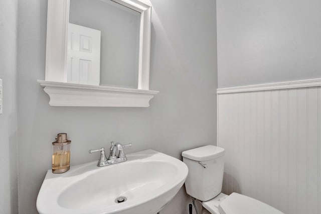 bathroom with toilet and a sink