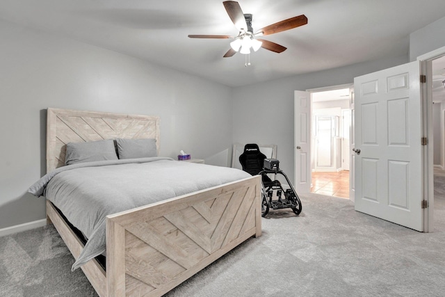 bedroom featuring ceiling fan and light carpet