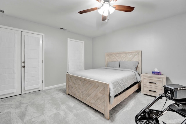 carpeted bedroom featuring visible vents, ceiling fan, and baseboards