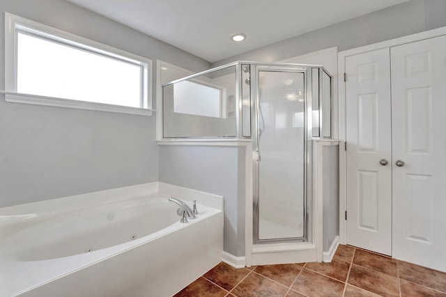 full bath with tile patterned flooring, a stall shower, and a whirlpool tub