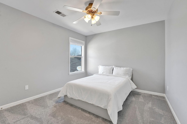 bedroom featuring visible vents, a ceiling fan, baseboards, and carpet floors