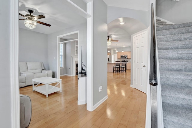 interior space featuring stairway, a ceiling fan, and light wood finished floors