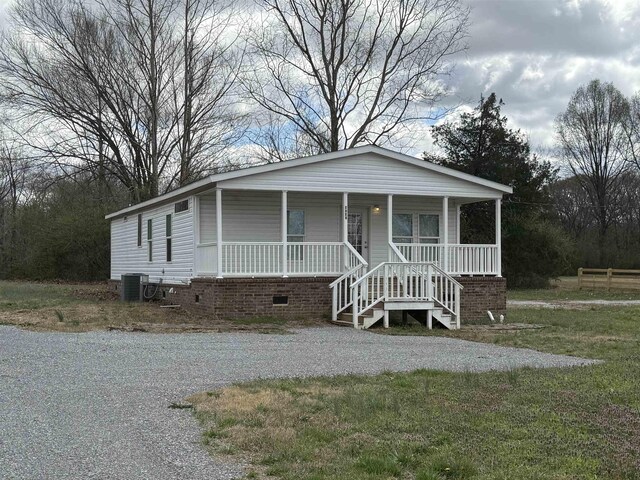 view of front of property with a porch, central air condition unit, and crawl space