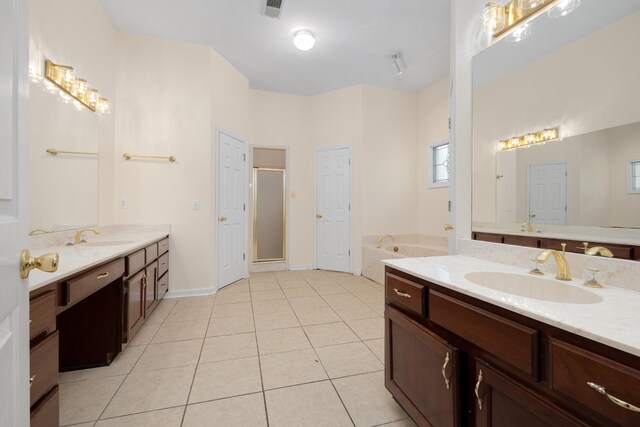 7570 Chapel Ridge Dr, Memphis, TN 38016 - full bathroom featuring a garden tub, two vanities, a stall shower, a sink, and tile patterned floors