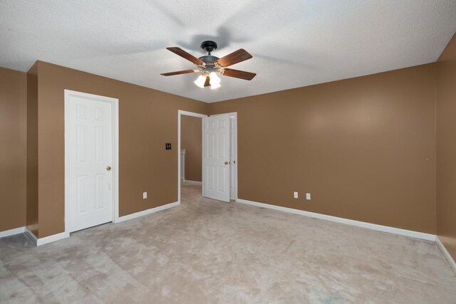 7570 Chapel Ridge Dr, Memphis, TN 38016 - unfurnished bedroom featuring baseboards, a textured ceiling, light carpet, and ceiling fan