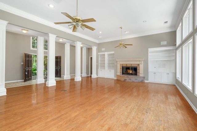 7570 Chapel Ridge Dr, Memphis, TN 38016 - unfurnished living room featuring built in shelves, ceiling fan, ornamental molding, a fireplace, and ornate columns