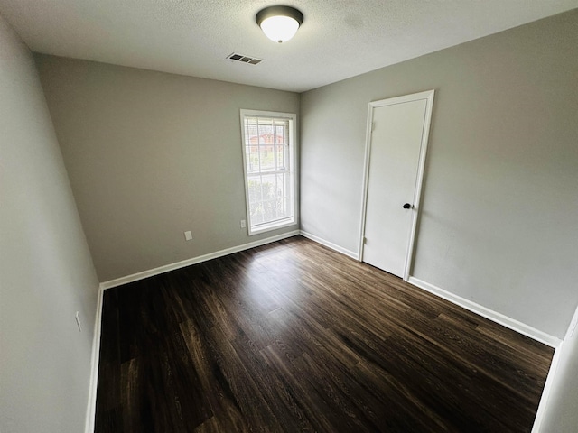 2260 Verse Cv, Memphis, TN 38127 - empty room with visible vents, a textured ceiling, baseboards, and dark wood-style flooring