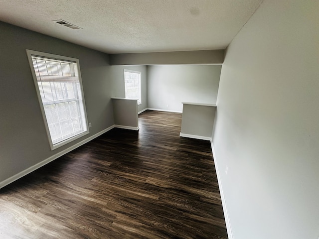 2260 Verse Cv, Memphis, TN 38127 - empty room with visible vents, a textured ceiling, dark wood-type flooring, and baseboards
