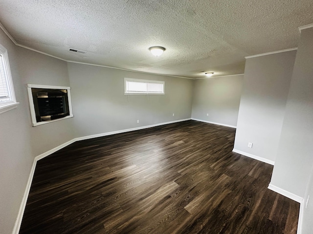 2260 Verse Cv, Memphis, TN 38127 - empty room with visible vents, ornamental molding, a glass covered fireplace, dark wood finished floors, and baseboards