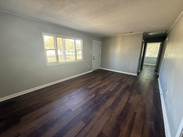 3617 Millington Rd, Memphis, TN 38127 - spare room featuring baseboards, a textured ceiling, attic access, and dark wood-style flooring